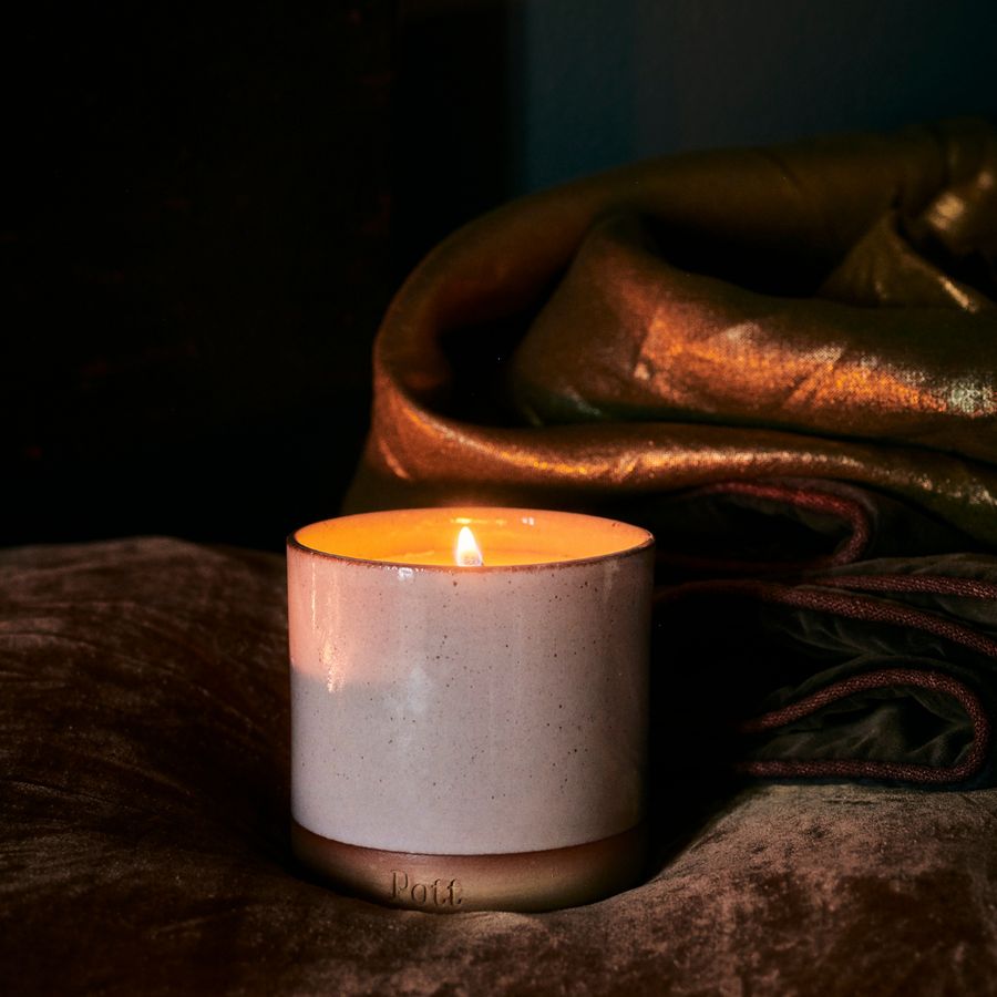 Tonka candle refill on a velvet throw